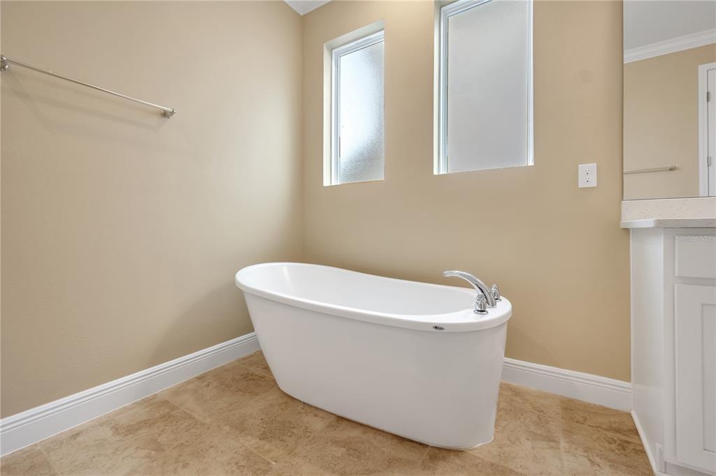 2132 Keystone Pass Boulevard Minneola, FL 34715 - Photo 15 of 52 a white bath tub sitting in a bathroom