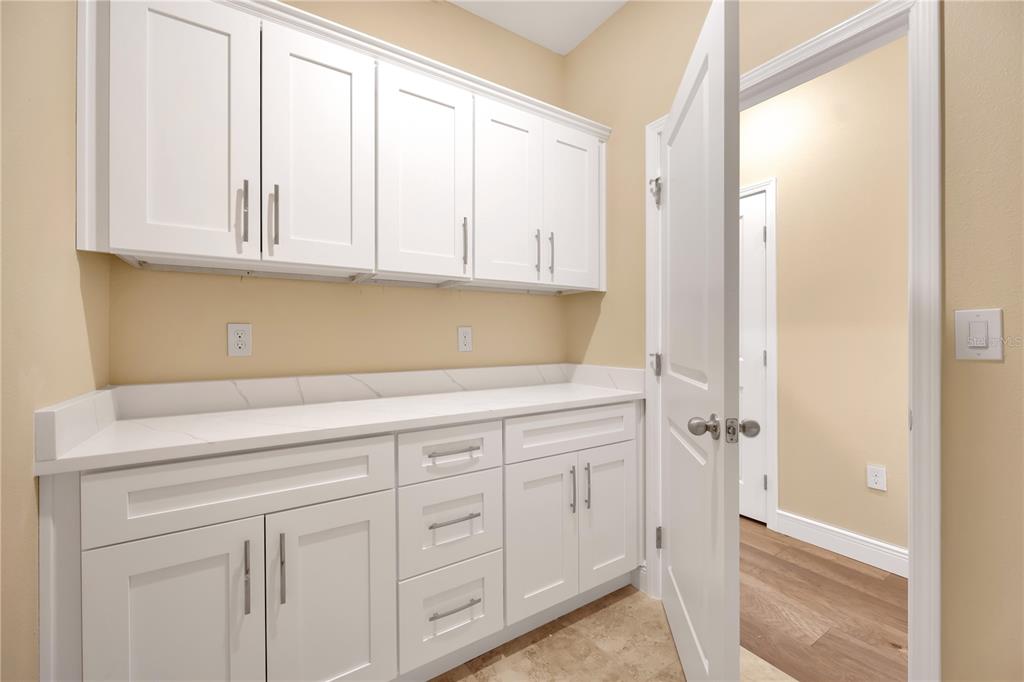 2132 Keystone Pass Boulevard Minneola, FL 34715 - Photo 22 of 52 a kitchen with white cabinets and a sink
