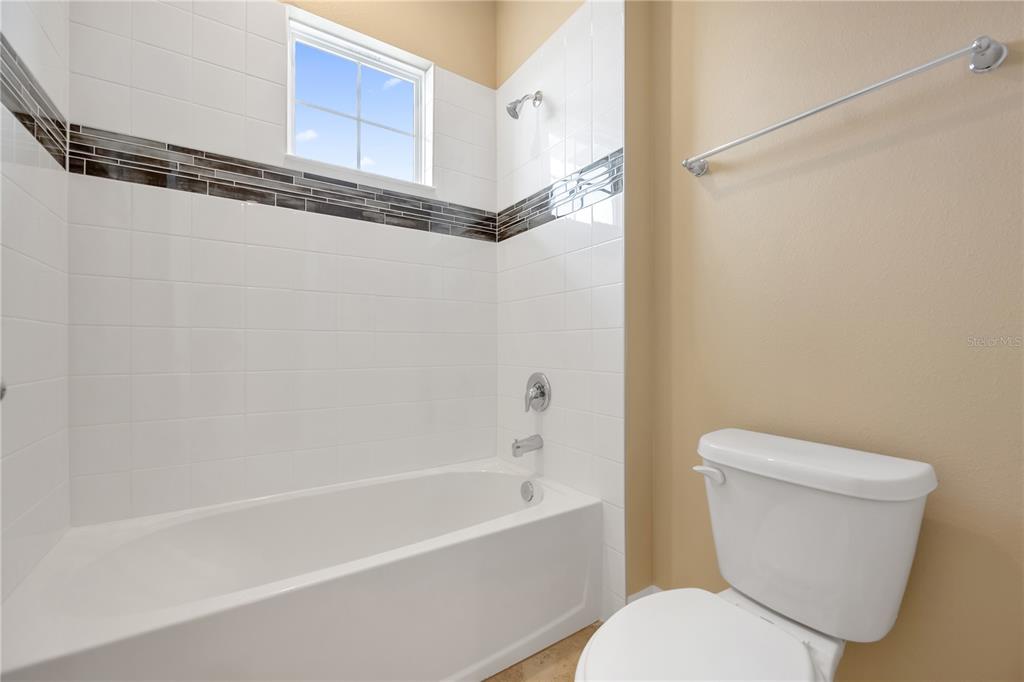 2132 Keystone Pass Boulevard Minneola, FL 34715 - Photo 26 of 52 a bathroom with a toilet and a bathtub