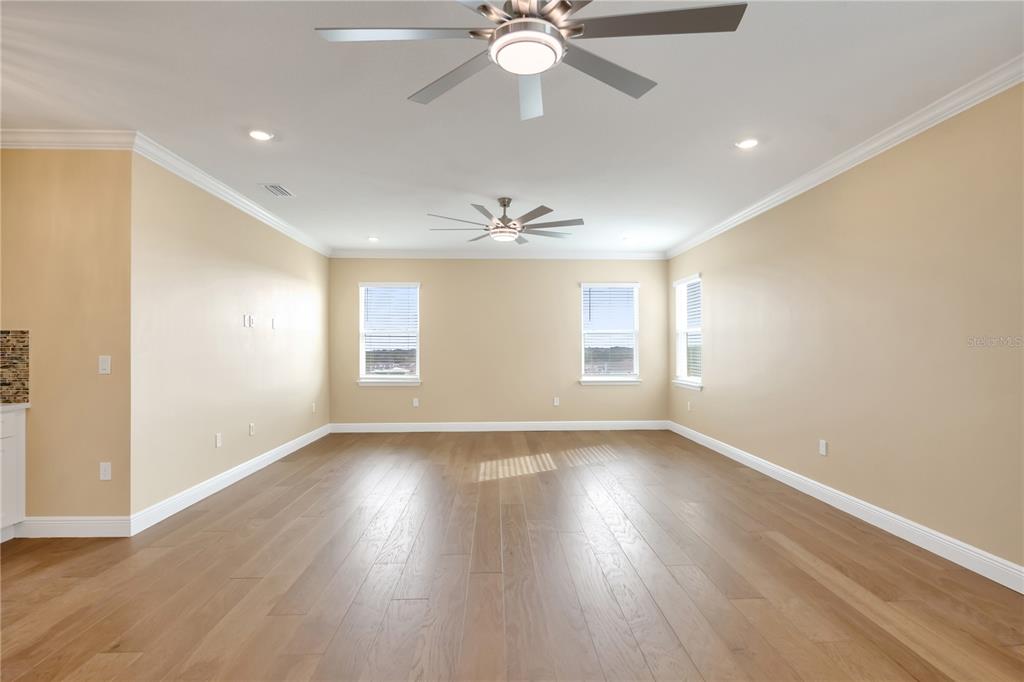 2132 Keystone Pass Boulevard Minneola, FL 34715 - Photo 29 of 52 a view of an empty room with wooden floor and a window