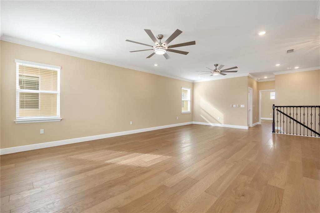 2132 Keystone Pass Boulevard Minneola, FL 34715 - Photo 32 of 52 a view of an empty room with window and wooden floor