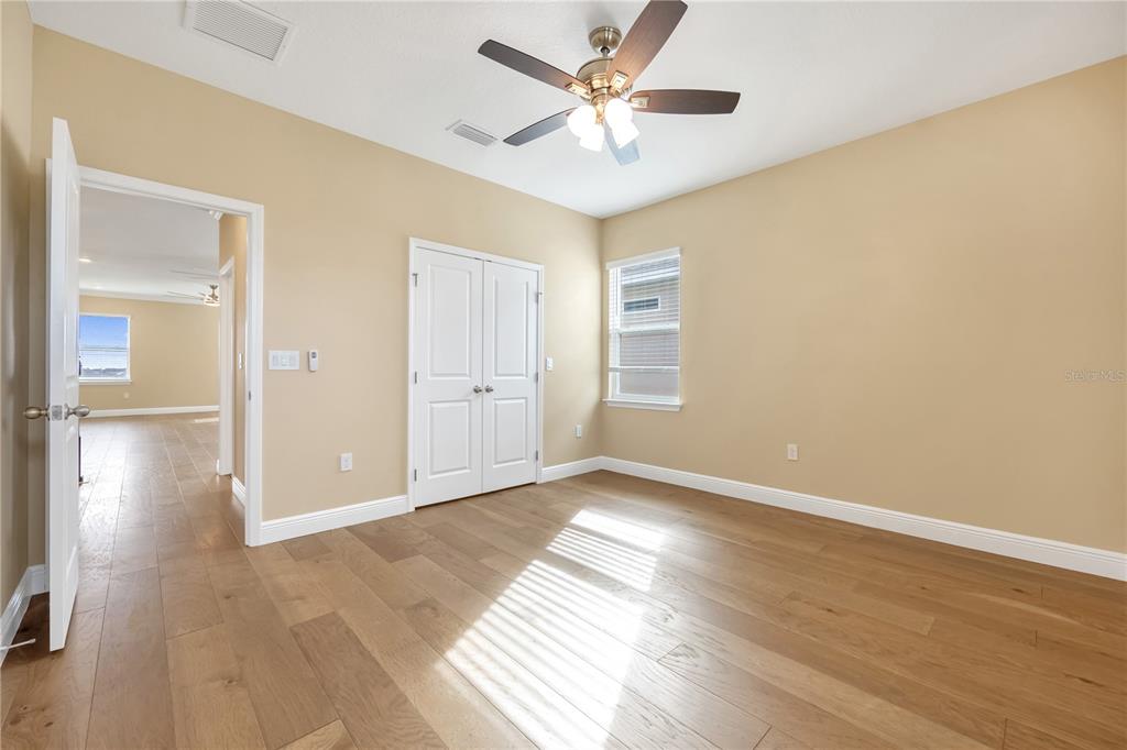 2132 Keystone Pass Boulevard Minneola, FL 34715 - Photo 36 of 52 an empty room with wooden floor and windows