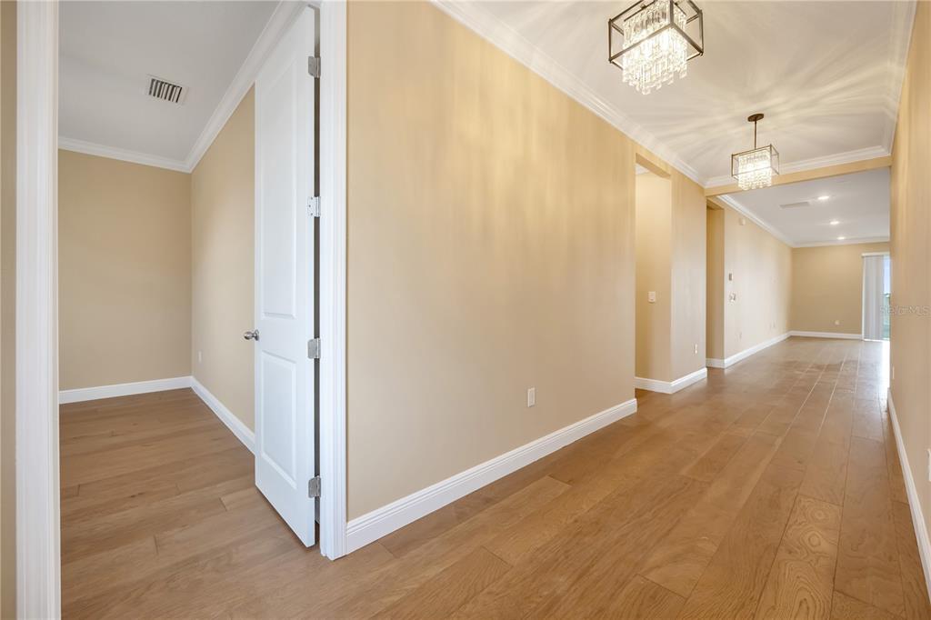 2132 Keystone Pass Boulevard Minneola, FL 34715 - Photo 38 of 52 a view of a hallway with wooden floor