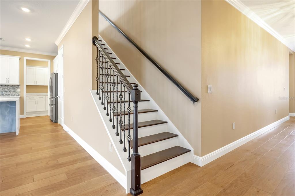 2132 Keystone Pass Boulevard Minneola, FL 34715 - Photo 4 of 52 a view of a hallway with wooden floor and staircase