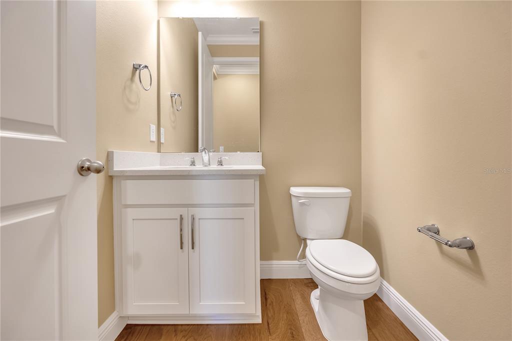 2132 Keystone Pass Boulevard Minneola, FL 34715 - Photo 41 of 52 a bathroom with a toilet sink and mirror