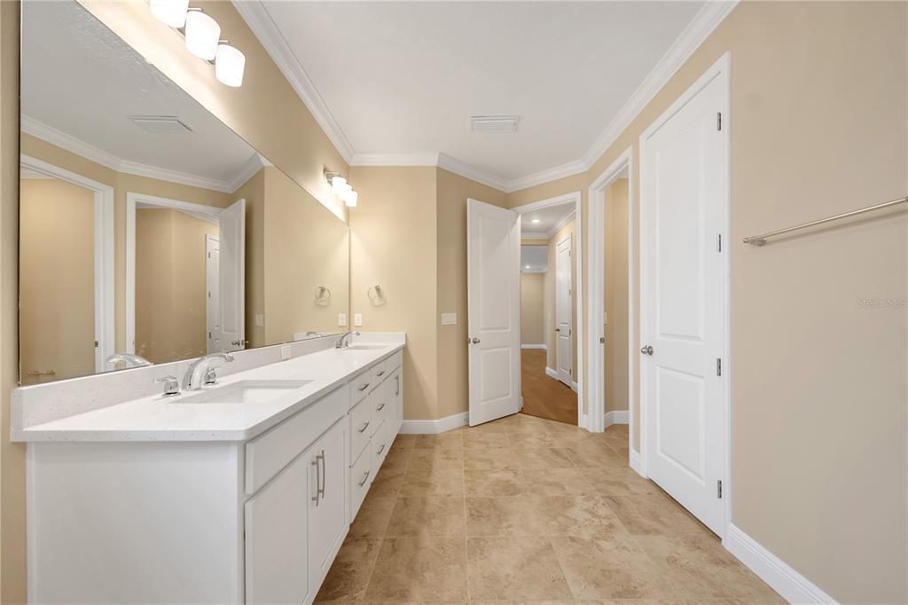 2132 Keystone Pass Boulevard Minneola, FL 34715 - Photo 48 of 52 a spacious bathroom with a double vanity sink and a mirror