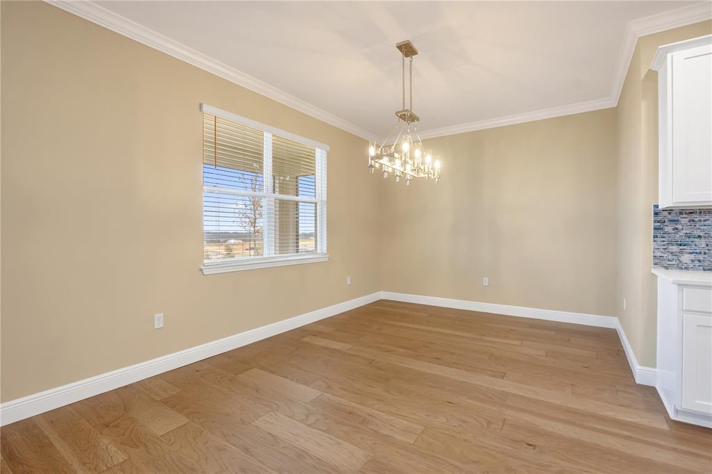 2132 Keystone Pass Boulevard Minneola, FL 34715 - Photo 7 of 52 a view of an empty room with wooden floor and a window