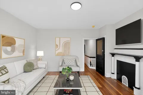 a view of a room with wooden floor and entryway