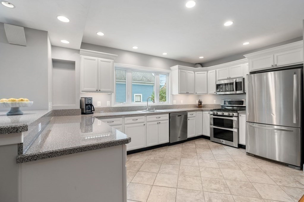 6 Willow Street Natick, MA 01760 - Photo 11 of 32 a kitchen with a sink stainless steel appliances and cabinets