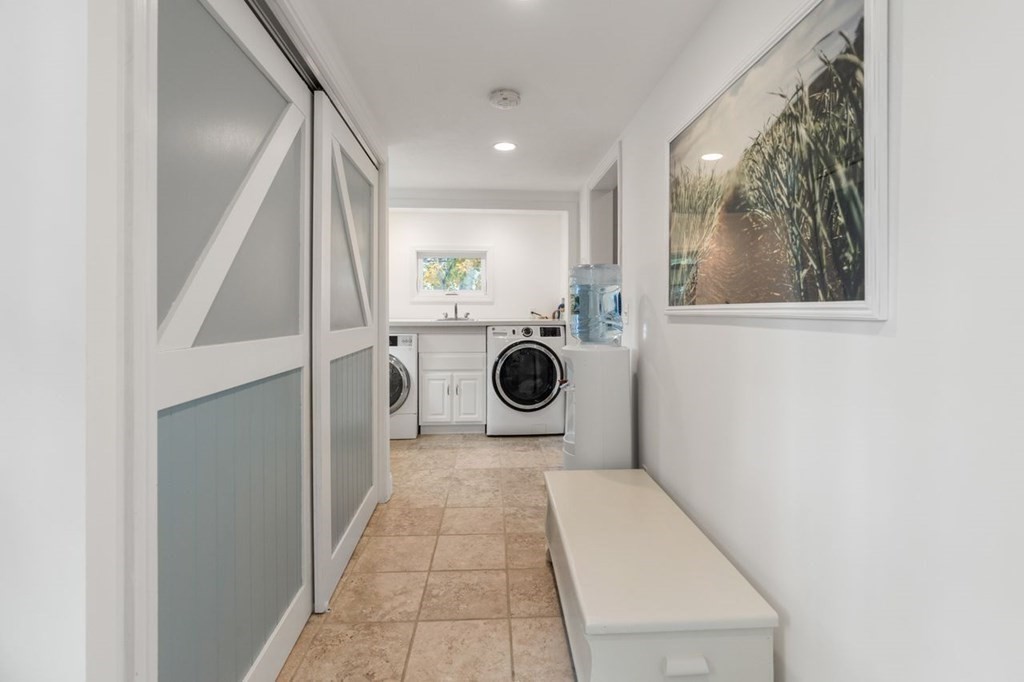 6 Willow Street Natick, MA 01760 - Photo 21 of 32 a hallway with a washer and dryer