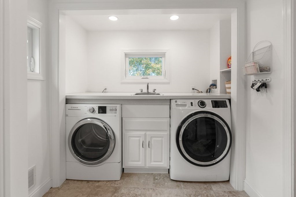 6 Willow Street Natick, MA 01760 - Photo 23 of 32 a view of a hallway with washer and dryer