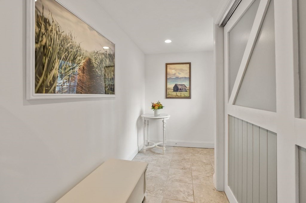 6 Willow Street Natick, MA 01760 - Photo 24 of 32 a view of a hallway with wooden floor and a workspace