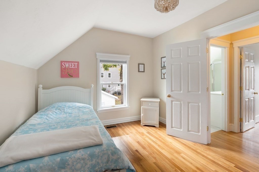 6 Willow Street Natick, MA 01760 - Photo 29 of 32 a bedroom with a bed and wooden floor