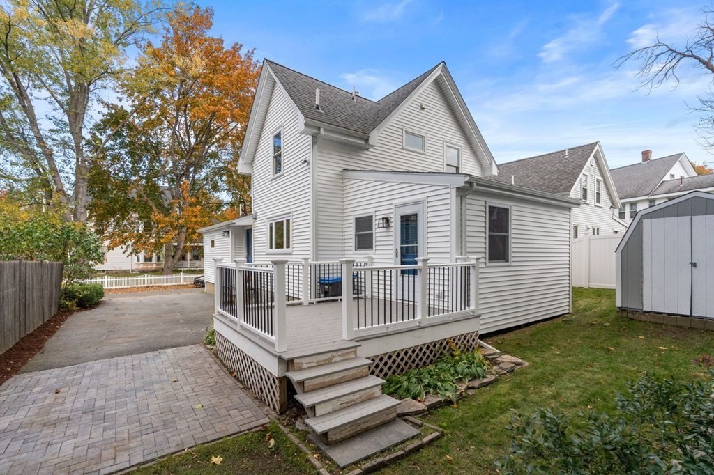6 Willow Street Natick, MA 01760 - Photo 6 of 32 a view of a white house with a yard and large tree