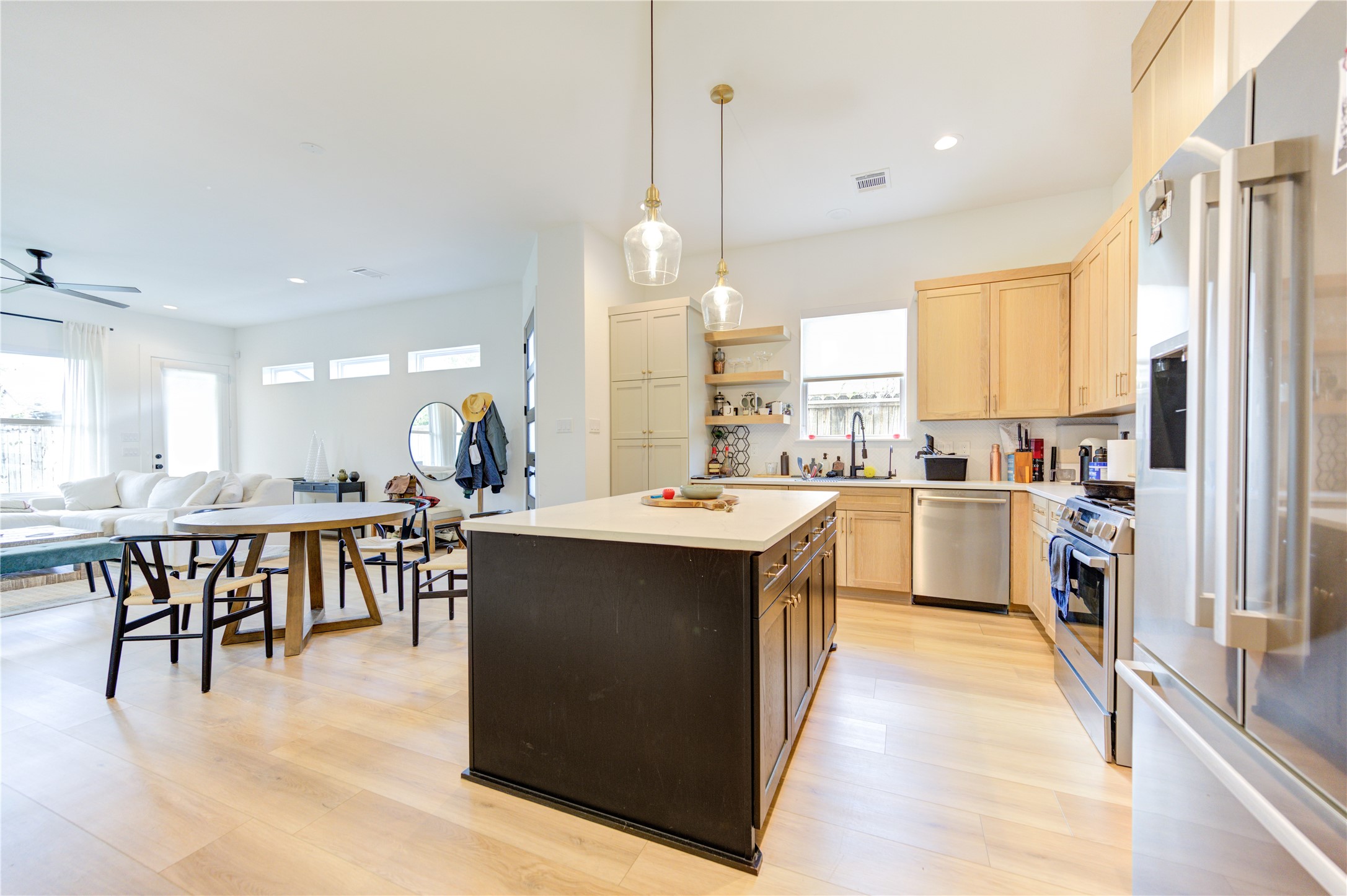 18 Sidney Street, Unit A Houston, TX 77003 - Photo 12 of 30 a large kitchen with kitchen island a sink a stove a dining table and chairs