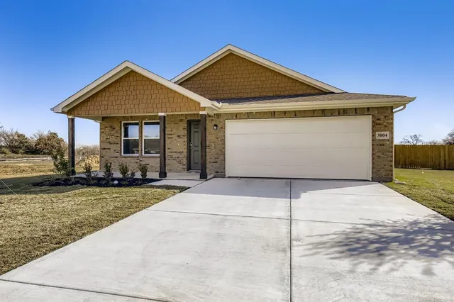 a front view of a house with yard