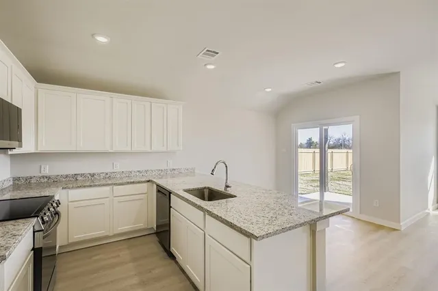 a kitchen that has a sink and a stove in it