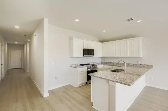 a kitchen with a sink stove and refrigerator