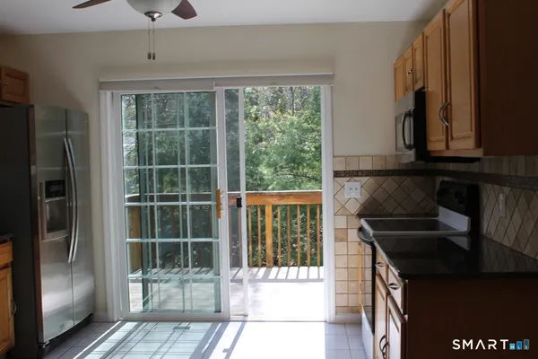 a kitchen with a sink a refrigerator and cabinets