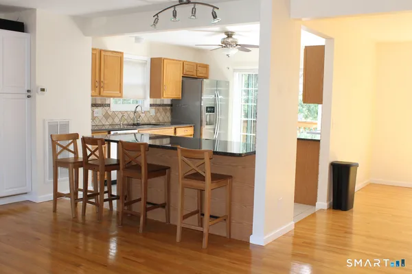 a dining room with furniture and wooden floor