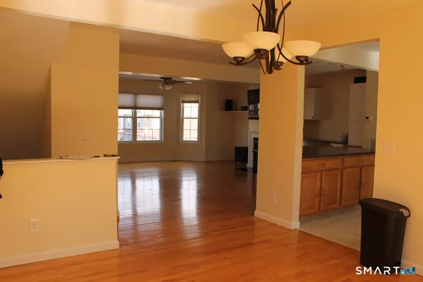 a view of hallway with wooden floor