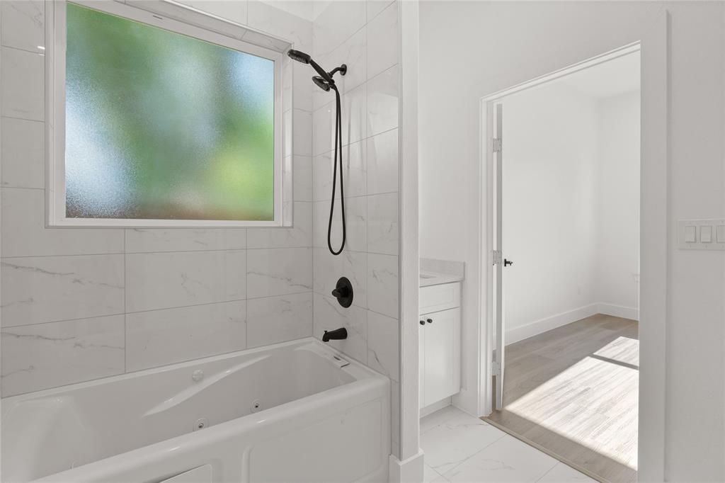 504 South Tennessee Street McKinney, TX 75069 - Photo 15 of 40 Bathroom featuring marble finish floors, a combined bath / shower with jetted tub, and vanity