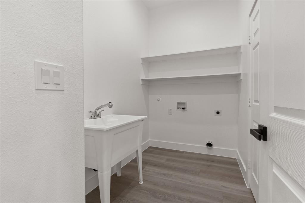504 South Tennessee Street McKinney, TX 75069 - Photo 18 of 40 Laundry area with hookup for an electric dryer, dark wood-style floors, hookup for a washing machine, gas dryer hookup, and a textured wall
