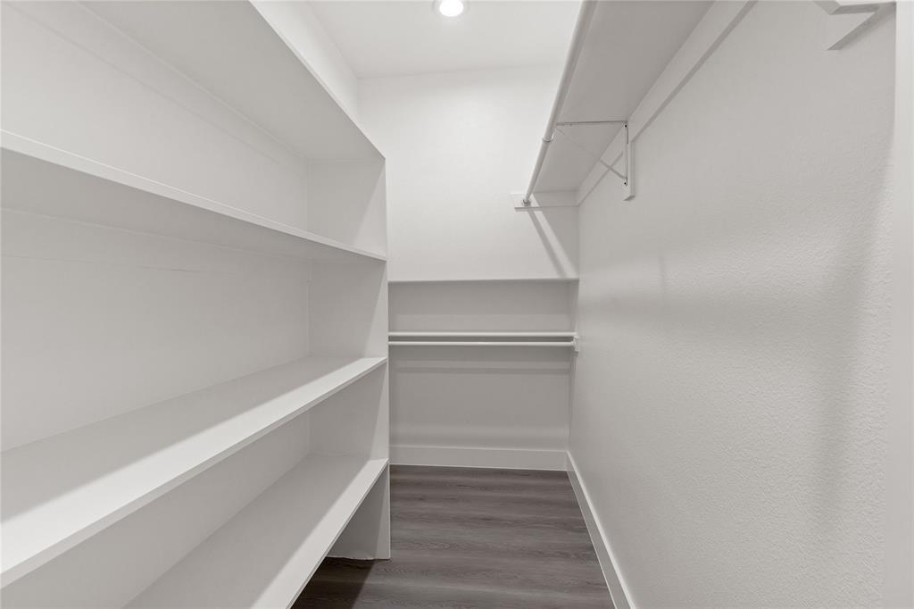 504 South Tennessee Street McKinney, TX 75069 - Photo 32 of 40 Spacious closet featuring dark wood finished floors