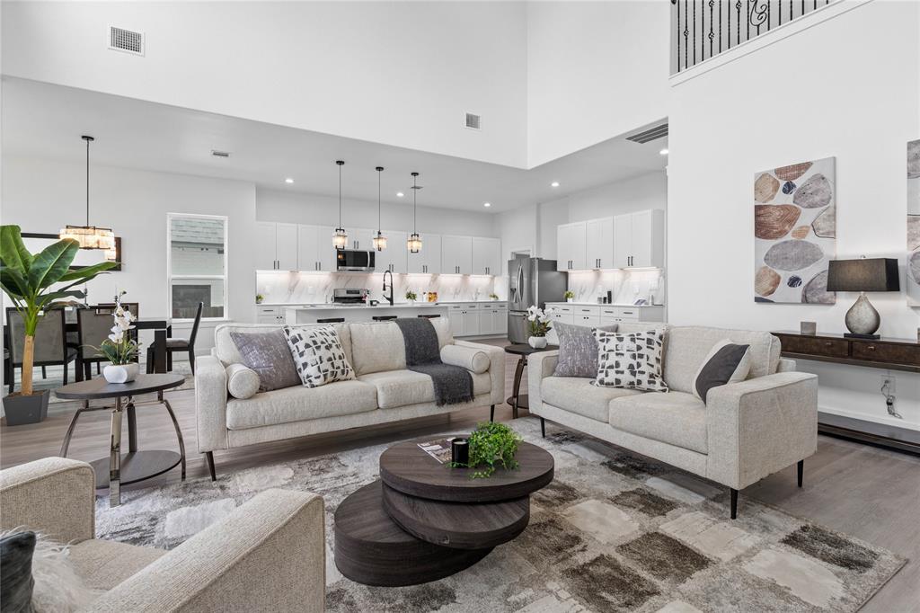 504 South Tennessee Street McKinney, TX 75069 - Photo 7 of 40 Living room featuring wood finished floors and a towering ceiling
