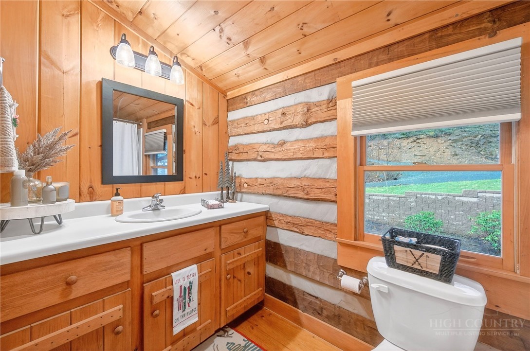 376 Yellow Bear Road Todd, NC 28684 - Photo 22 of 29 a bathroom with a sink a large mirror and a window