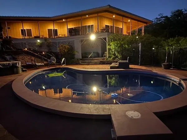 an aerial view of a house with a yard and a garage