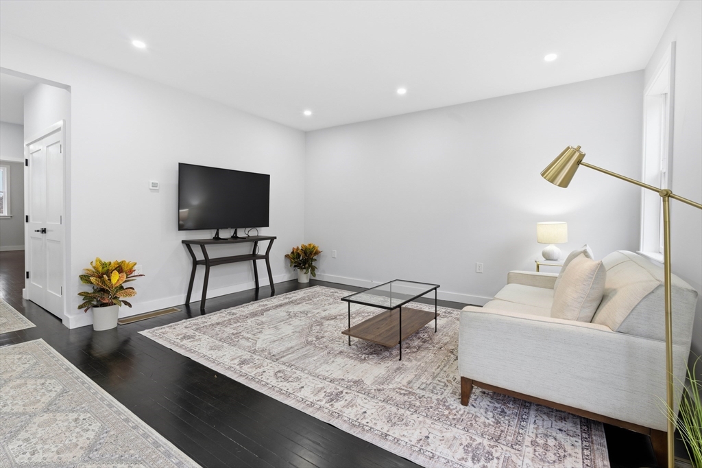 288 Grove Street, Unit 288 Clinton, MA 01510 - Photo 12 of 37 a living room with furniture and a flat screen tv