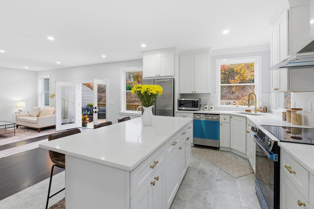 288 Grove Street, Unit 288 Clinton, MA 01510 - Photo 9 of 37 a kitchen with a sink a counter top space stainless steel appliances and cabinets