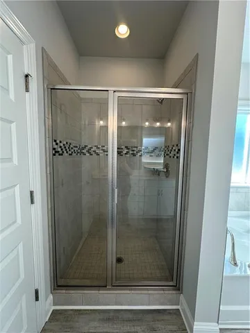 a bathroom with a glass shower door