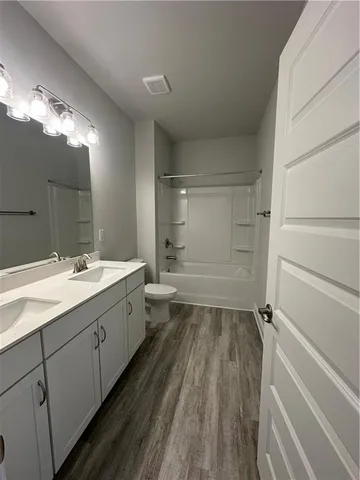 a bathroom with a double vanity sink and mirror