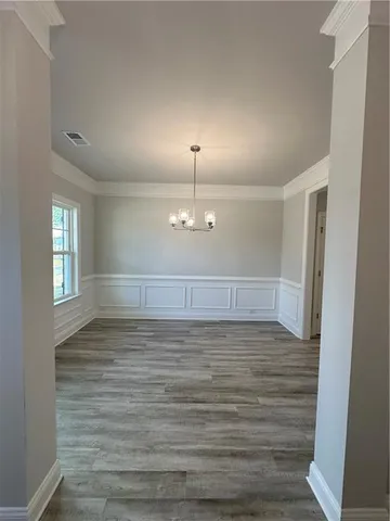 a view of a room with wooden floor and window
