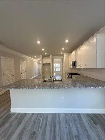 a view of a kitchen with a sink and a stove top oven