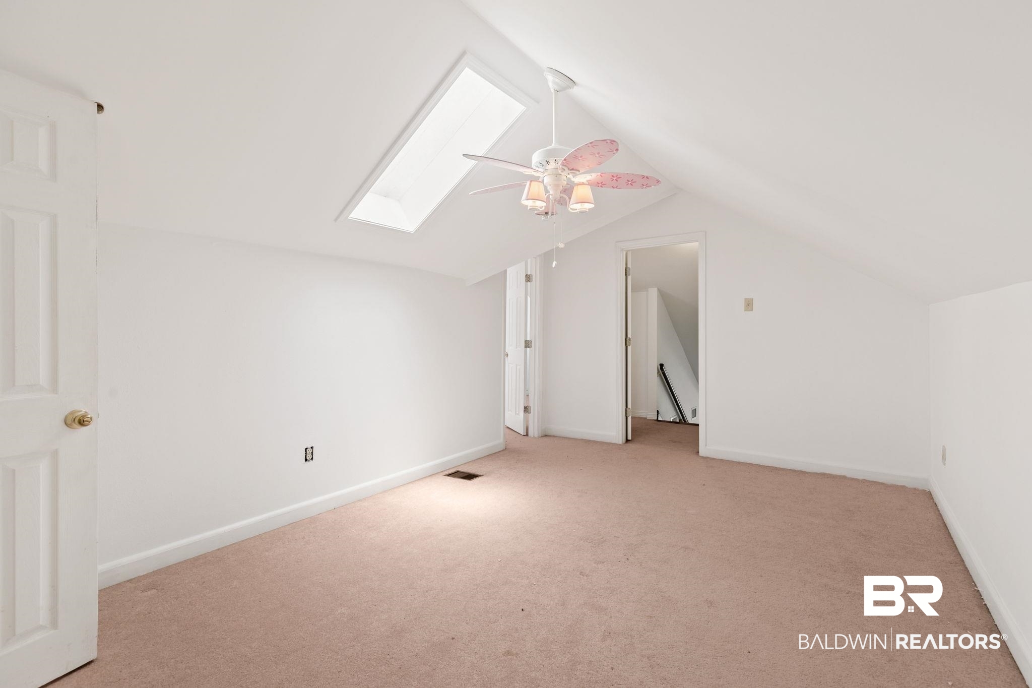 927 Cleveland Road Saraland, AL 36571 - Photo 43 of 80 Sloped ceiling room featuring a skylight, ceiling fan with light fixture, carpet flooring, and white interior doors