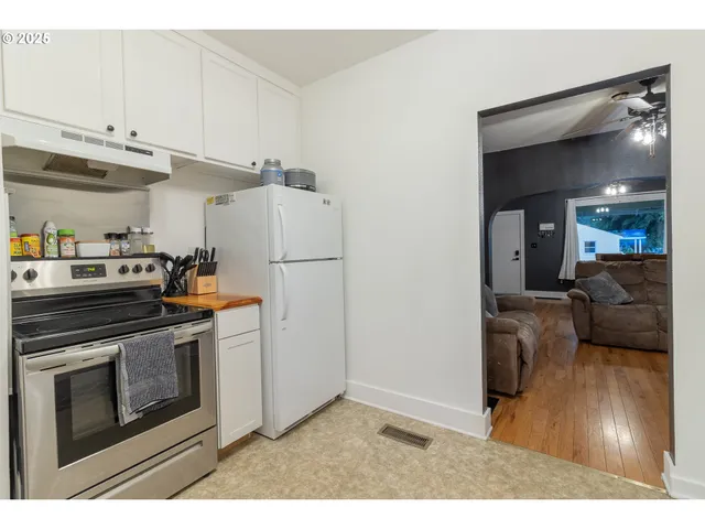 a kitchen with cabinets and steel stainless steel appliances