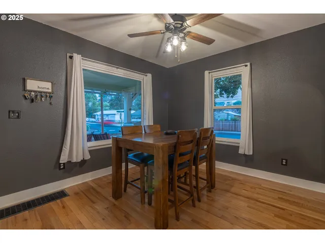 a view of a dining room with furniture and a window