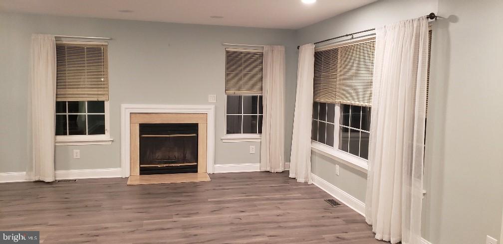 11 Castleton Road Princeton, NJ 08540 - Photo 3 of 7 a view of a livingroom with wooden floor and a fireplace