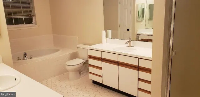 a view of a big room with wooden floor and windows