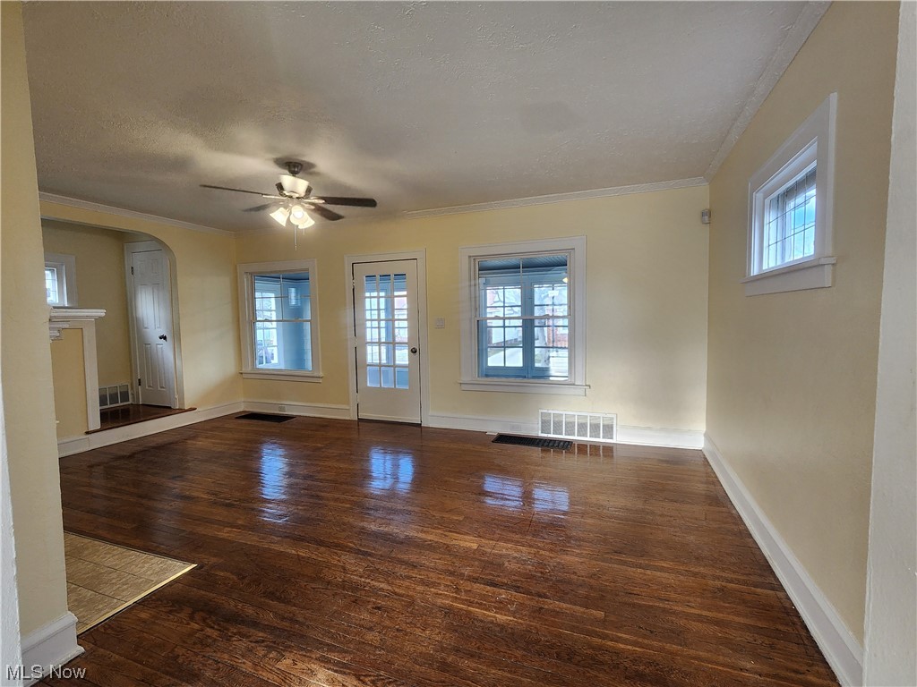 17814 Crestland Road Cleveland, OH 44119 - Photo 5 of 49 Living room featuring crown molding, dark hardwood / wood-style flooring, and ceiling fan