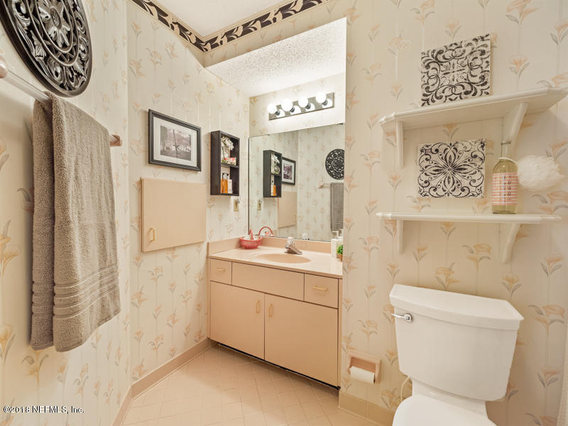 3134 Nautilus Road Middleburg, FL 32068 - Photo 34 of 46 a bathroom with a toilet sink and mirror