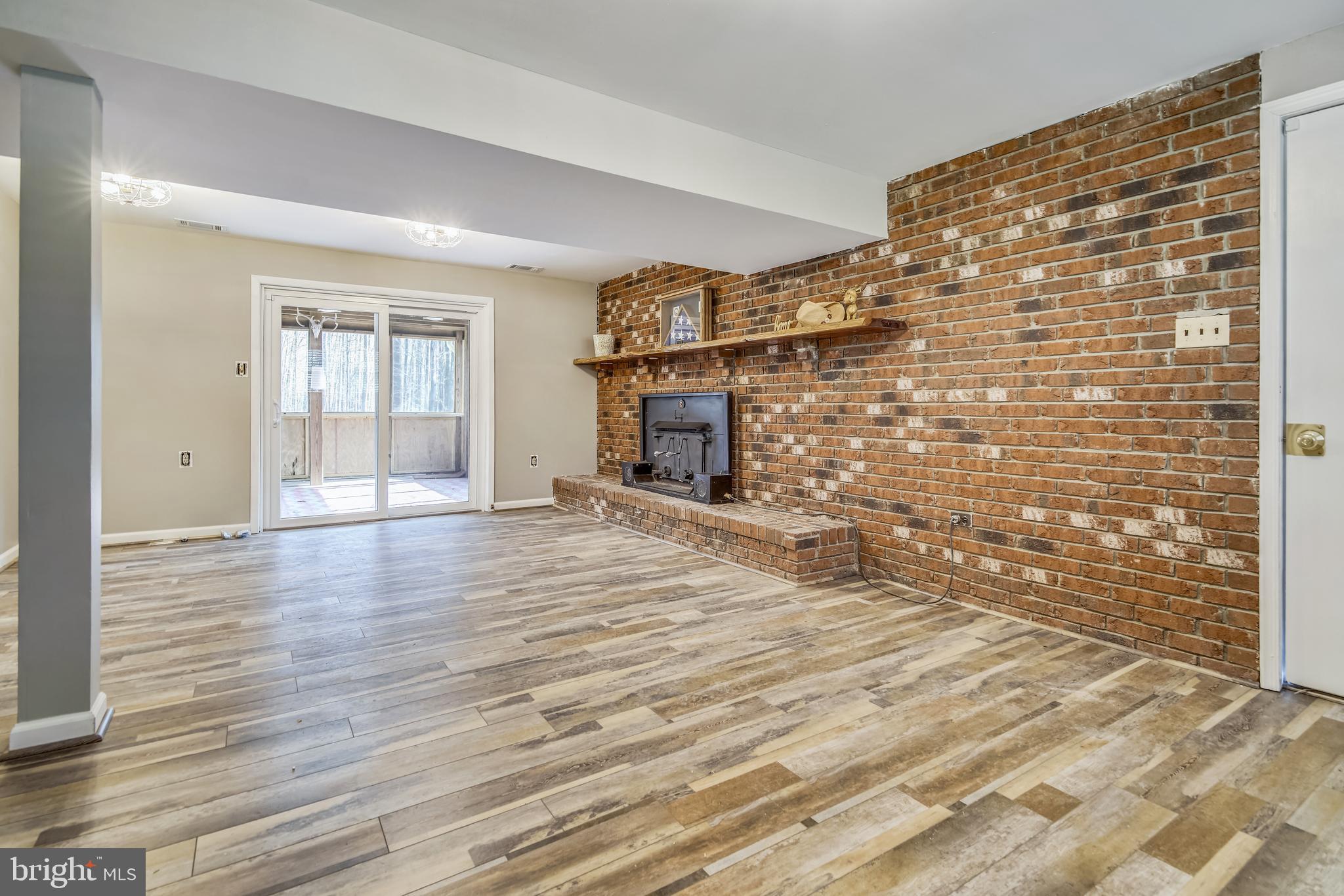 8845 Lowell Road Pomfret, MD 20675 - Photo 8 of 22 family room leading to screened porch