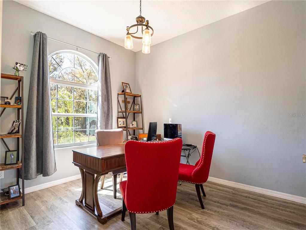 10688 Southwest 129th Terrace Road Dunnellon, FL 34432 - Photo 7 of 35 a view of a dining room with furniture window and wooden floor