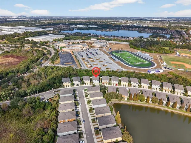 an aerial view of a residential houses with outdoor space and swimming pool