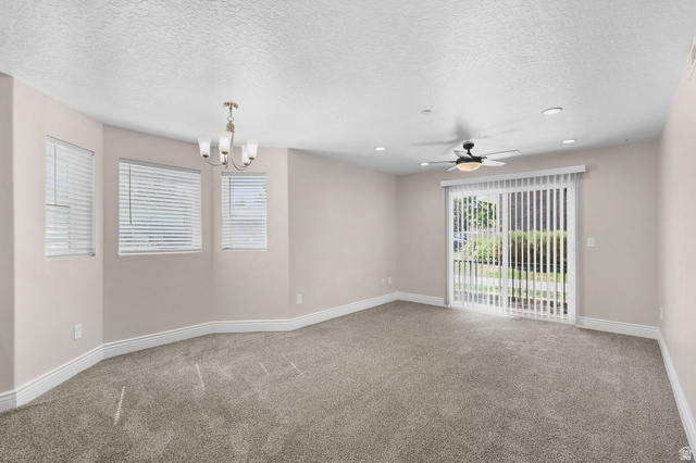 8264 South Resaca Drive, Unit K3 Sandy, UT 84070 - Photo 5 of 30 Spacious room featuring neutral paint, gray carpet, multiple windows with blinds, a ceiling fan, and recessed lighting