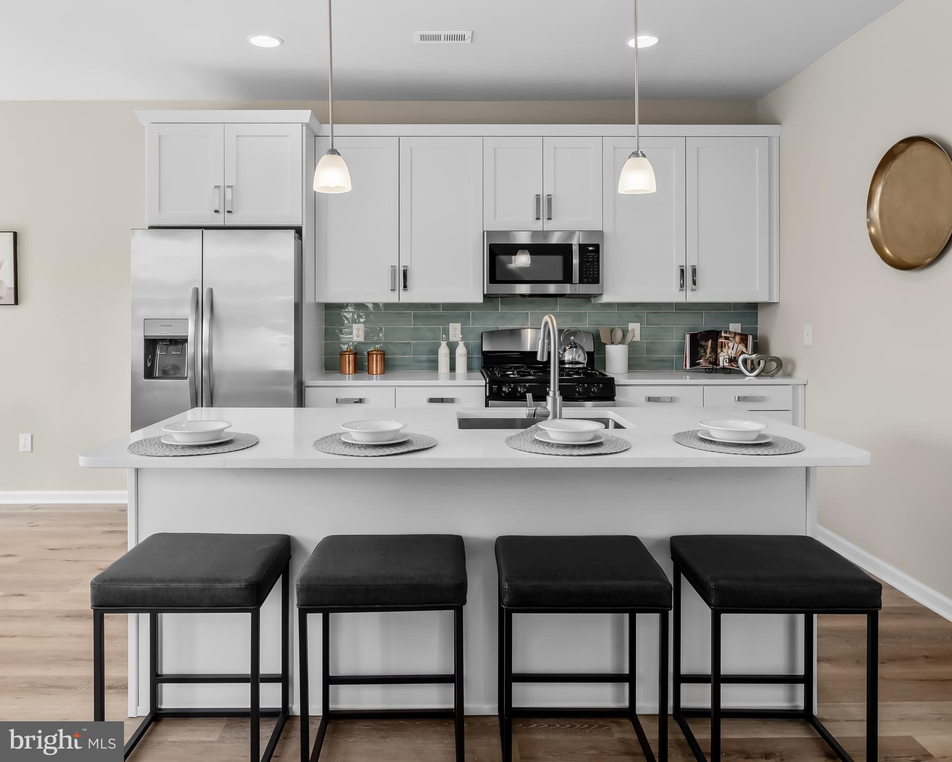 385 North Tuckahoe Road, Unit 961 Williamstown, NJ 08094 - Photo 5 of 21 a kitchen with stainless steel appliances a table chairs stove and cabinets