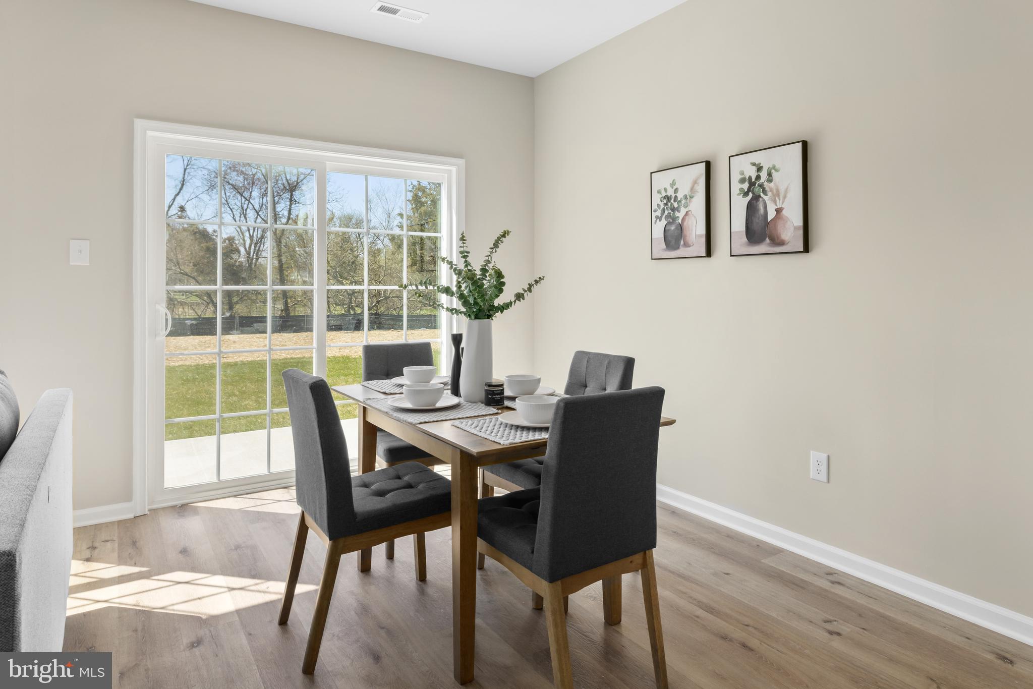 385 North Tuckahoe Road, Unit 961 Williamstown, NJ 08094 - Photo 9 of 21 a view of a dining room with furniture window and wooden floor